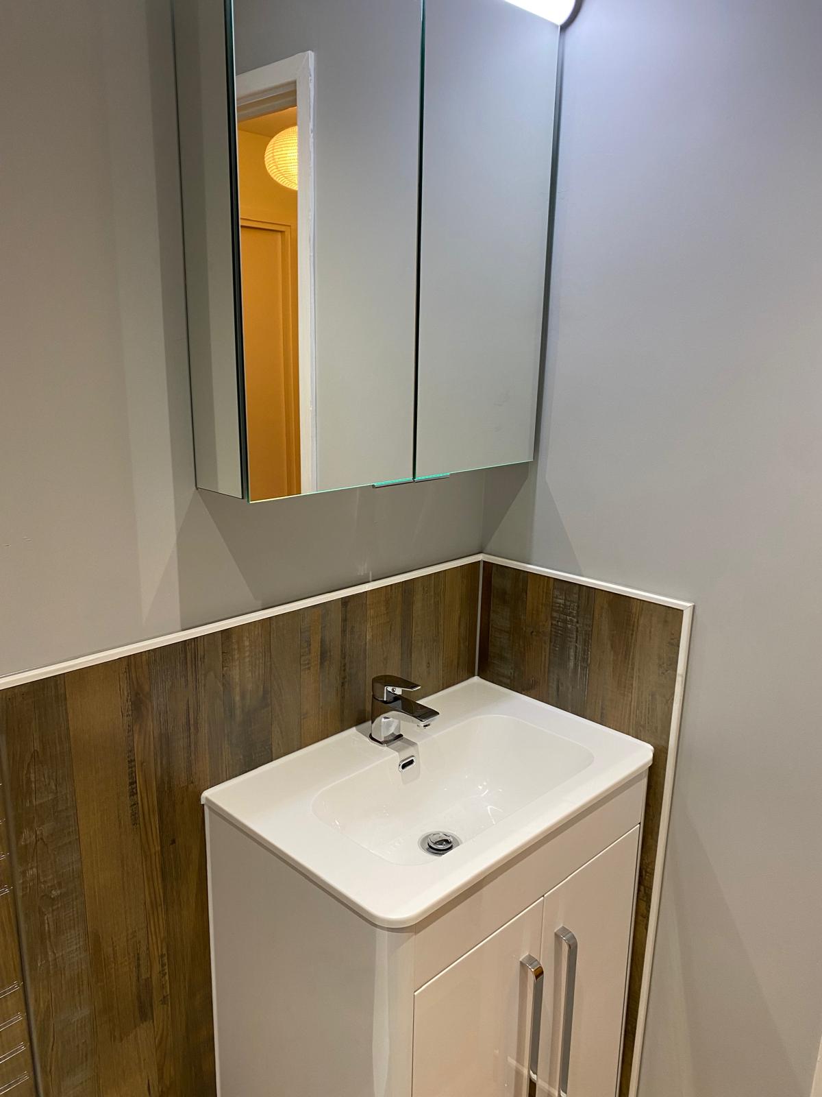 Bathroom installation with sink and mirror