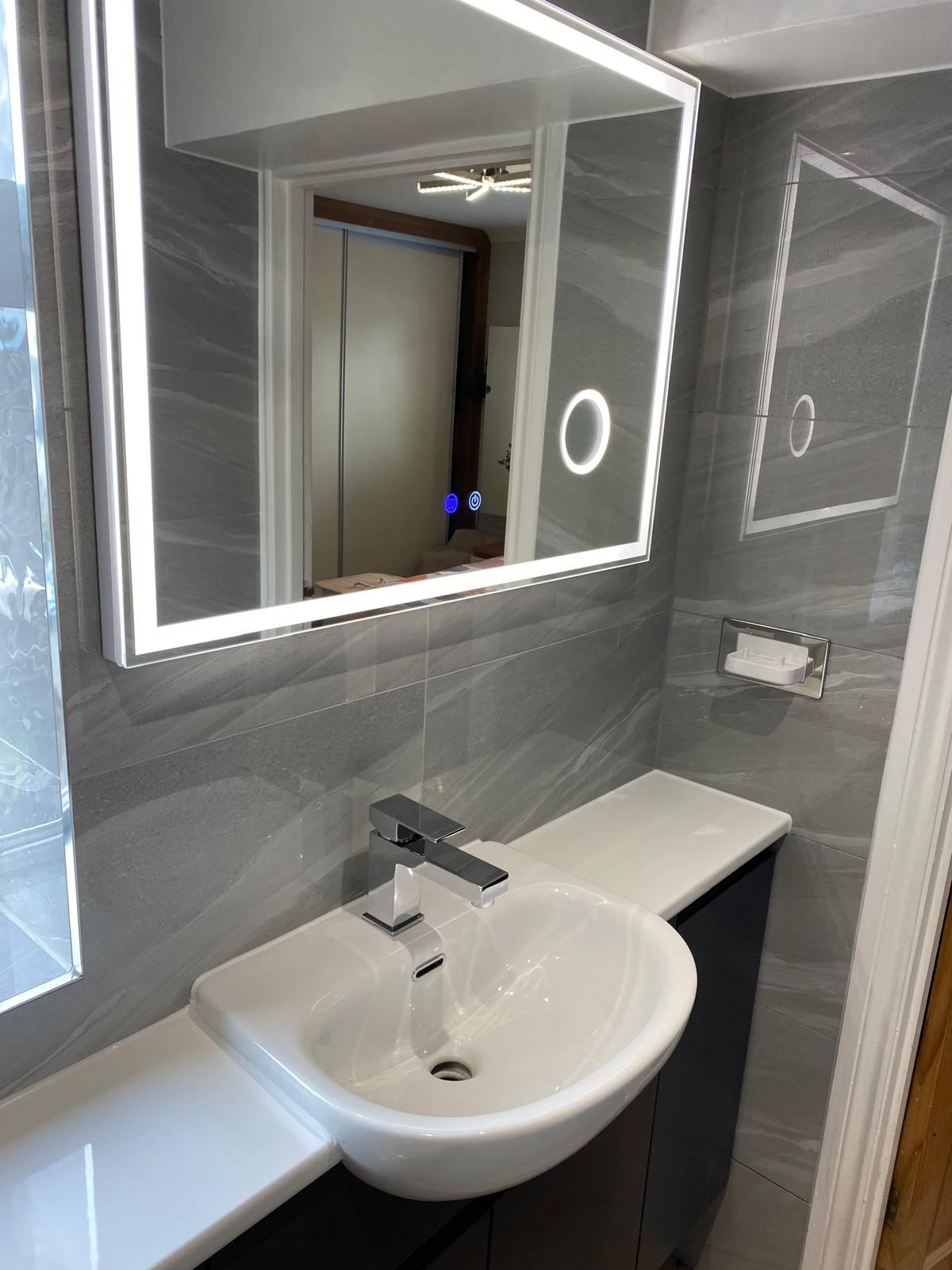 Bathroom installation with sink and mirror