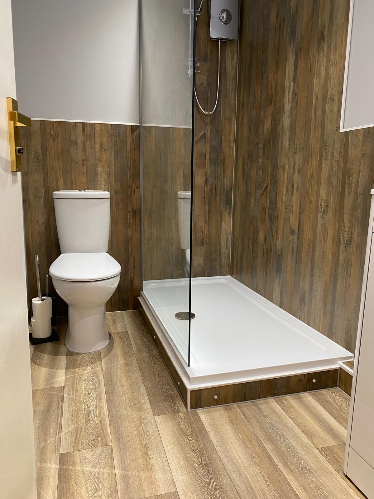 Bathroom installation with walk in shower and toilet