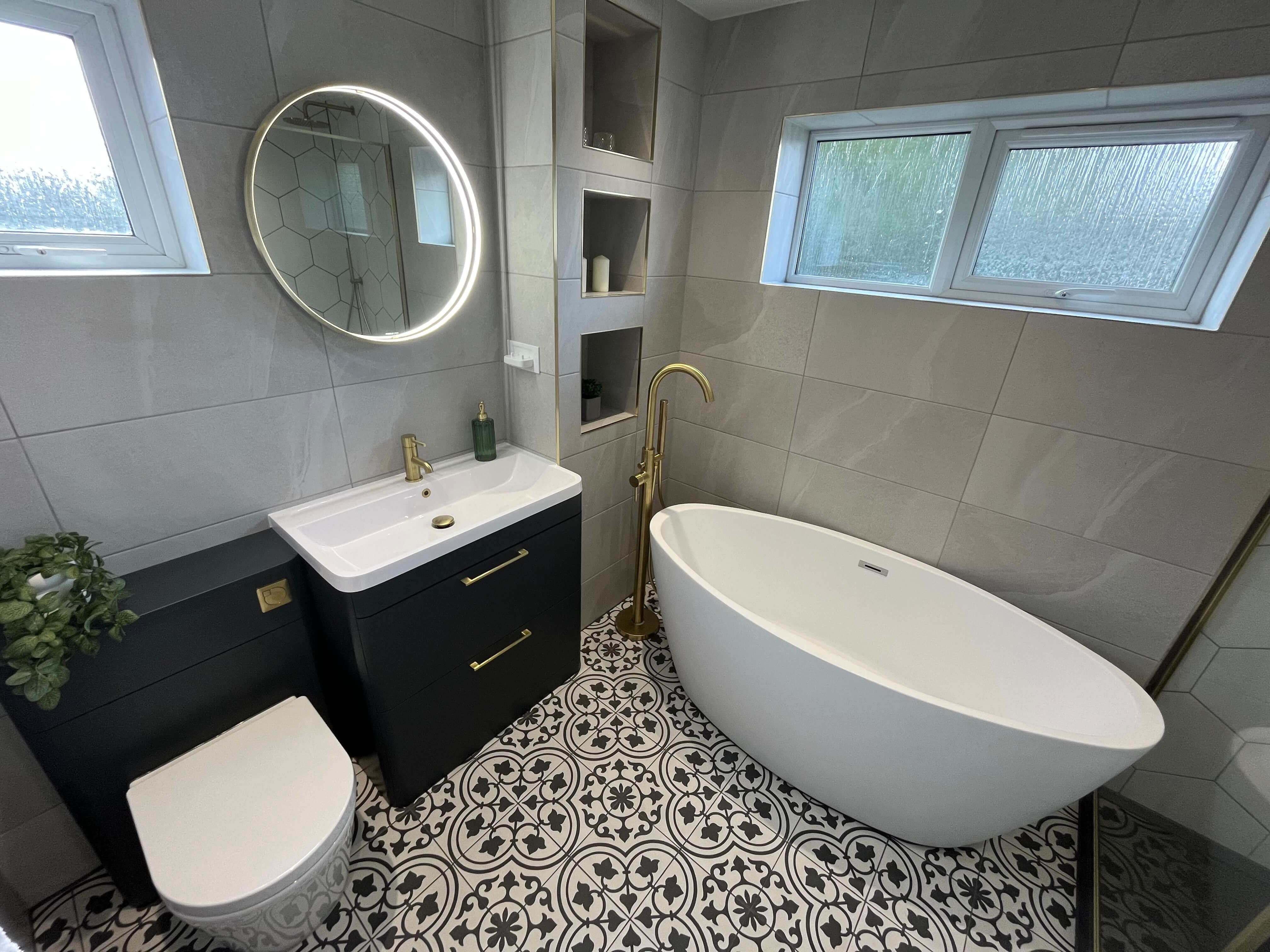 Renovated bathroom featuring sink. toilet, bath and storage